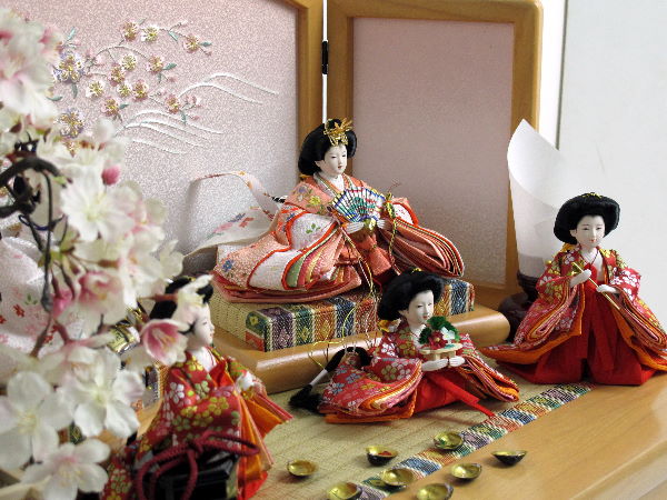 豆サイズの人形をピンクのコンパクトな収納台にセットした五人飾りです。桜の下で貝合わせを楽しみます。